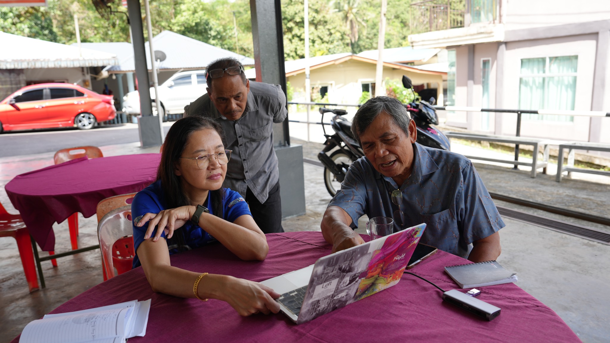 May be an image of 3 people and people studying